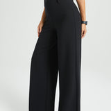 Black wide-leg pants worn by a woman on a white background