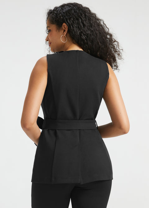 Back view of woman wearing black tailored ponte vest showing the belted waist, princess seaming and back vent