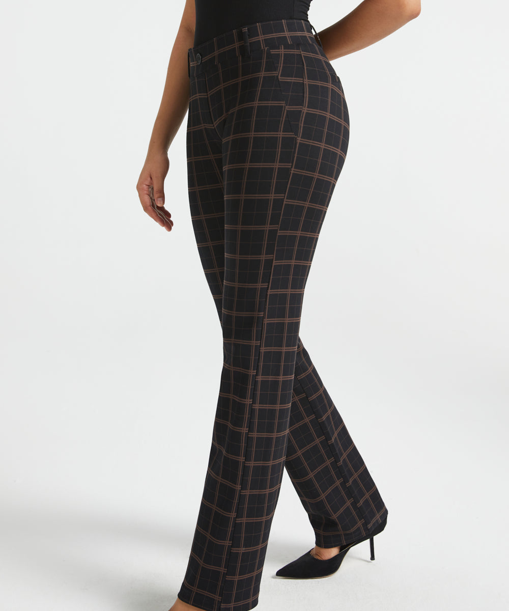 Woman wearing Black Brown Plaid straight-leg Dress Pant Yoga Pants with a black sleeveless top and black heels, side view