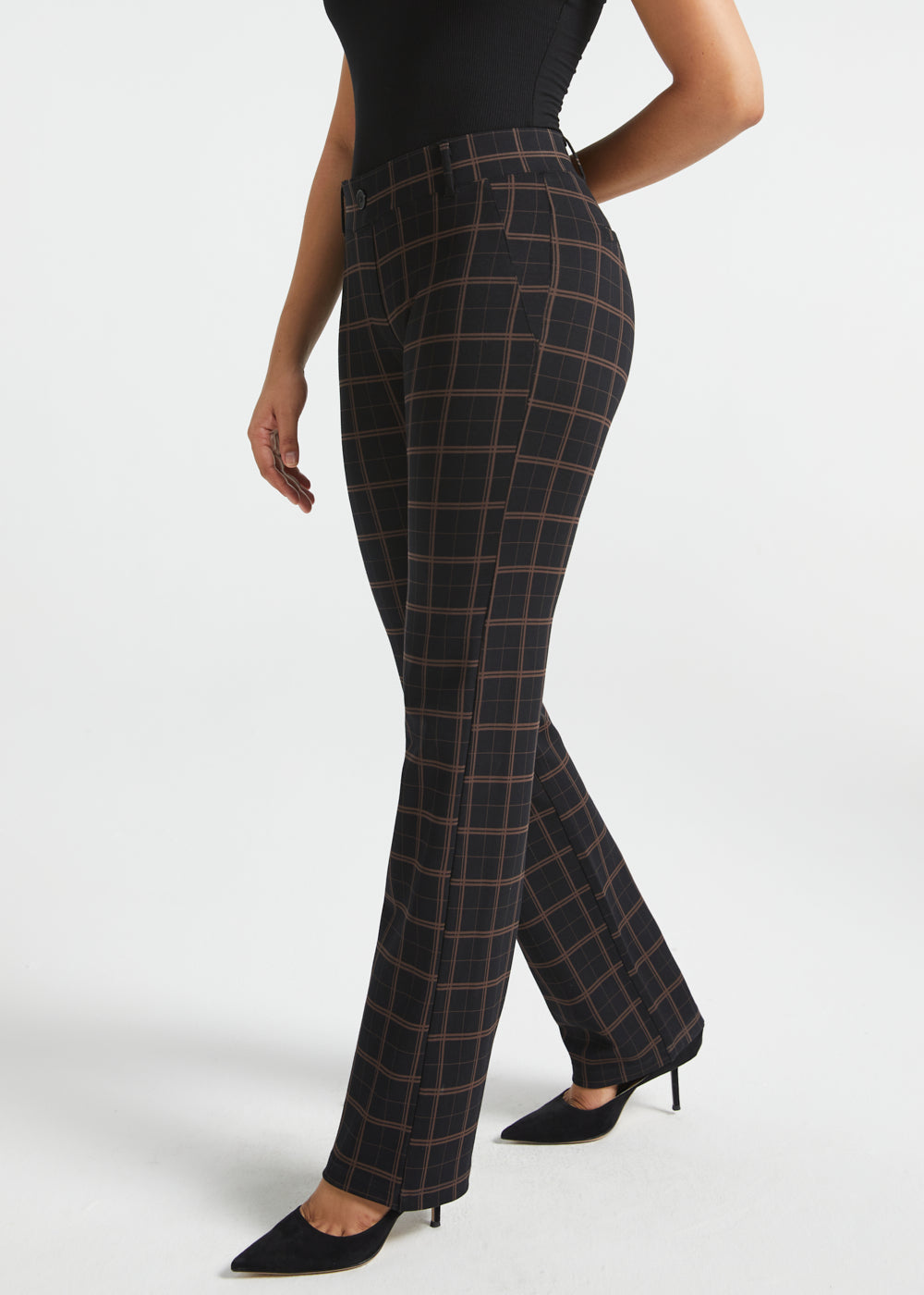 Woman wearing Black Brown Plaid straight-leg Dress Pant Yoga Pants with a black sleeveless top and black heels, side view