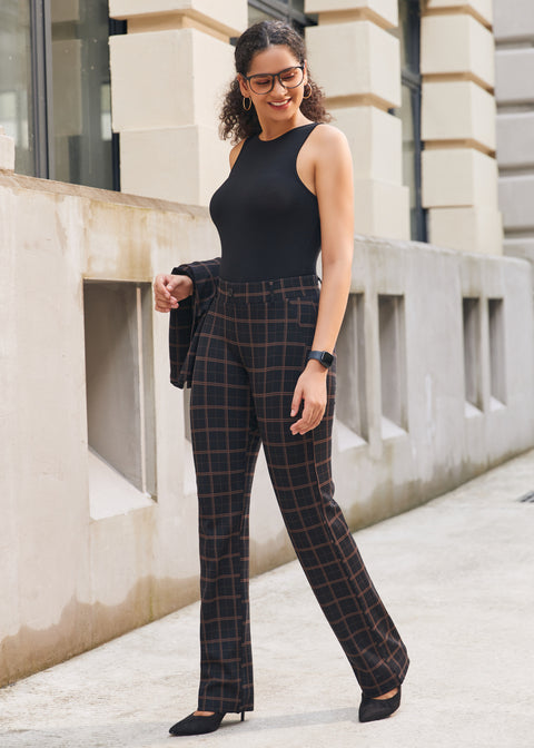 Woman wearing Black Brown Plaid straight-leg Dress Pant Yoga Pants with a black sleeveless top and black heels outdoors