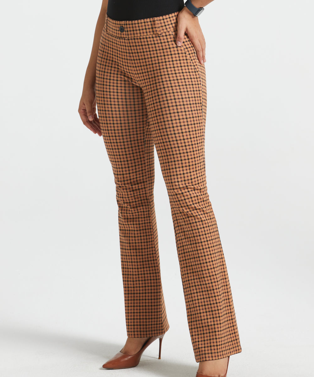 Woman wearing Camel Mini Houndstooth straight-leg Dress Pant Yoga Pants with a black sleeveless top and brown heels, front view