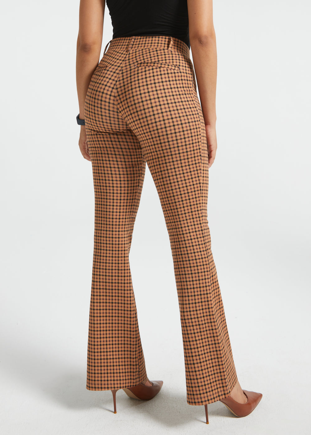 Back three-quarter view of woman wearing Camel Mini Houndstooth straight-leg Dress Pant Yoga Pants with brown heels