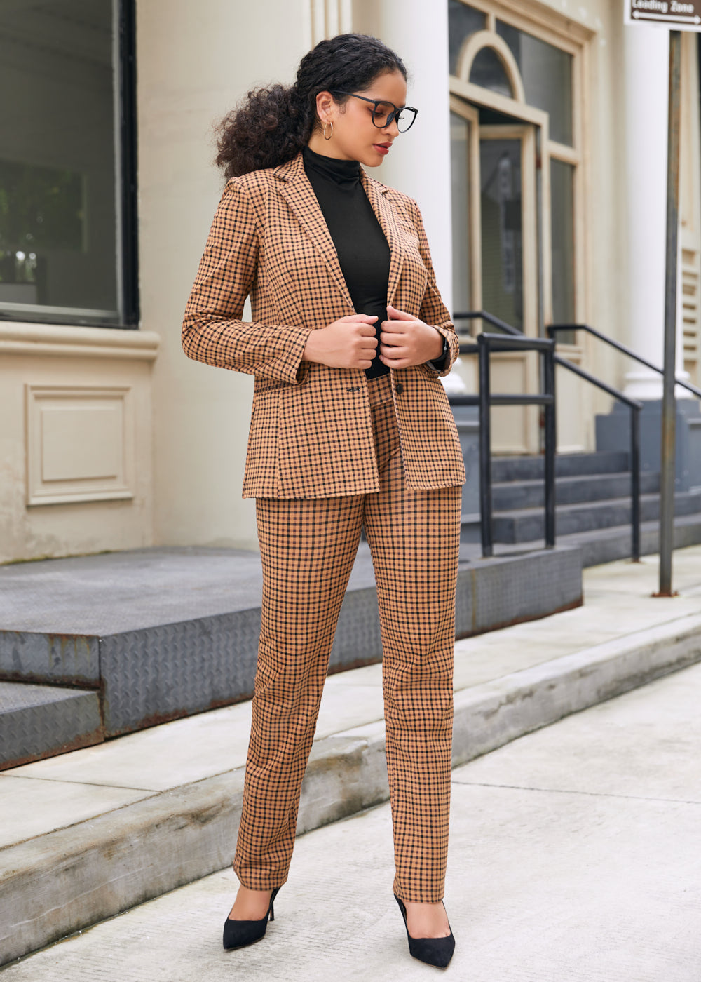 Woman wearing matching Camel Mini Houndstooth blazer and straight-leg Dress Pant Yoga Pants with black heels outdoors