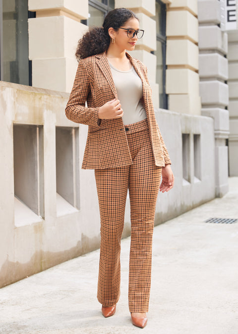 Woman wearing matching Camel Mini Houndstooth blazer and pants with a neutral top and brown heels outdoors