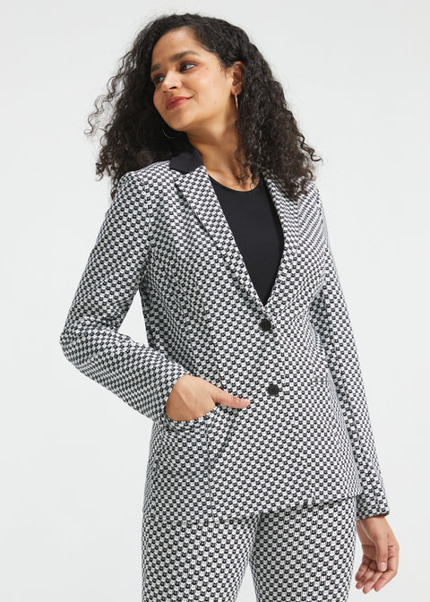 Woman wearing the black and ivory cat print Classic Blazer buttoned with one hand in the functional front pocket
