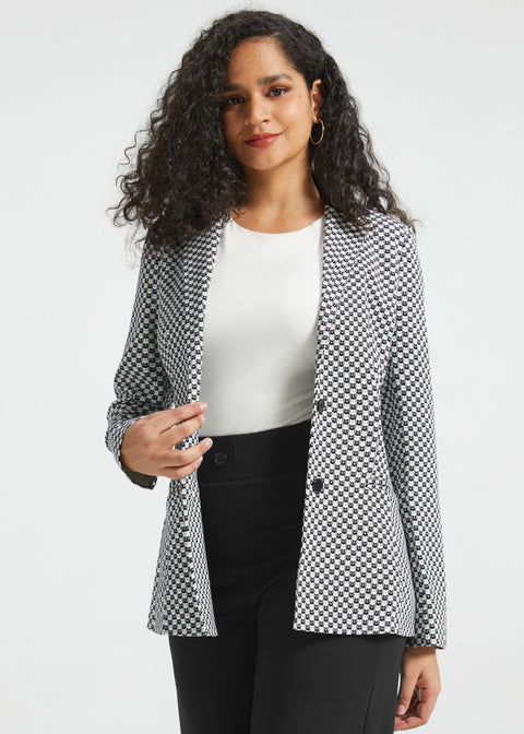 Woman wearing the Black Ivory Catstooth Classic Blazer open over a white top with black wide-leg pants