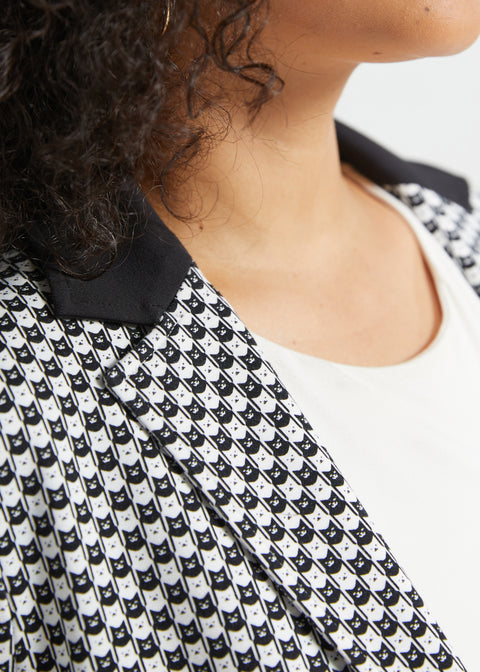 Close-up of the black and ivory cat print blazer showing the contrast black collar, notched lapel and tiny cat face pattern