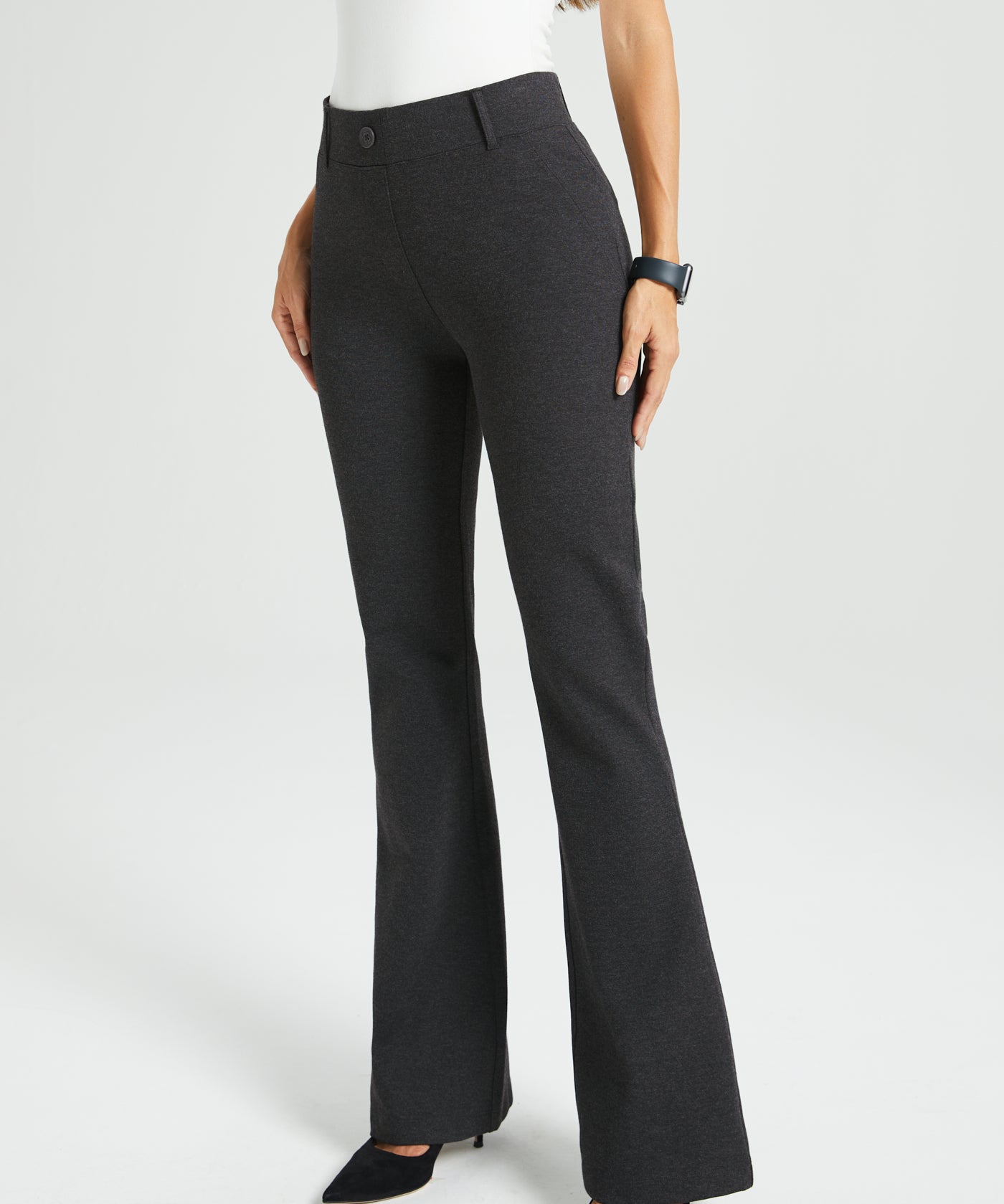 Dark gray flared dress pants worn by a woman on a white background